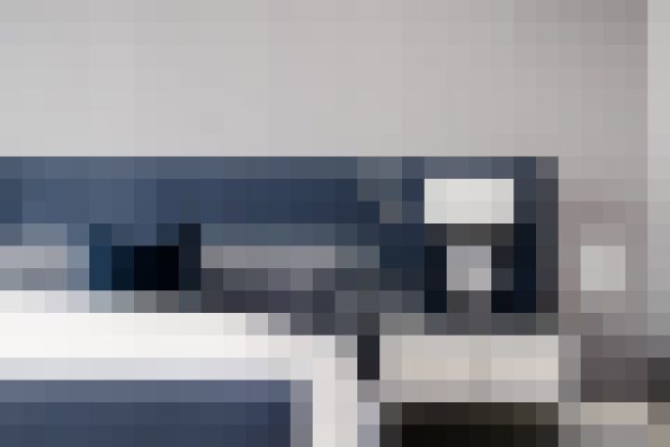 Blurred modern kitchen with dark blue cabinets and a white countertop island, creating a sleek, minimalist look