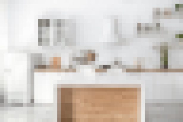 Bright white modern kitchen with an island featuring a wood-front panel and clean countertops trampling minimal decor